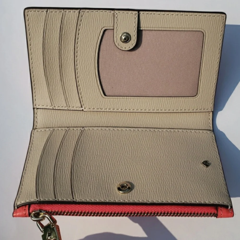 Kate Spade Leather Roulette Small Slim Bifold Wallet. Color: Peachmelba.